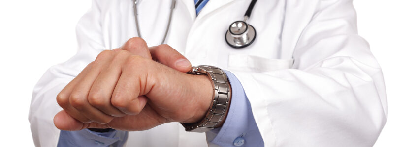 Doctor looking at watch checking the time concept for appointment or deadline